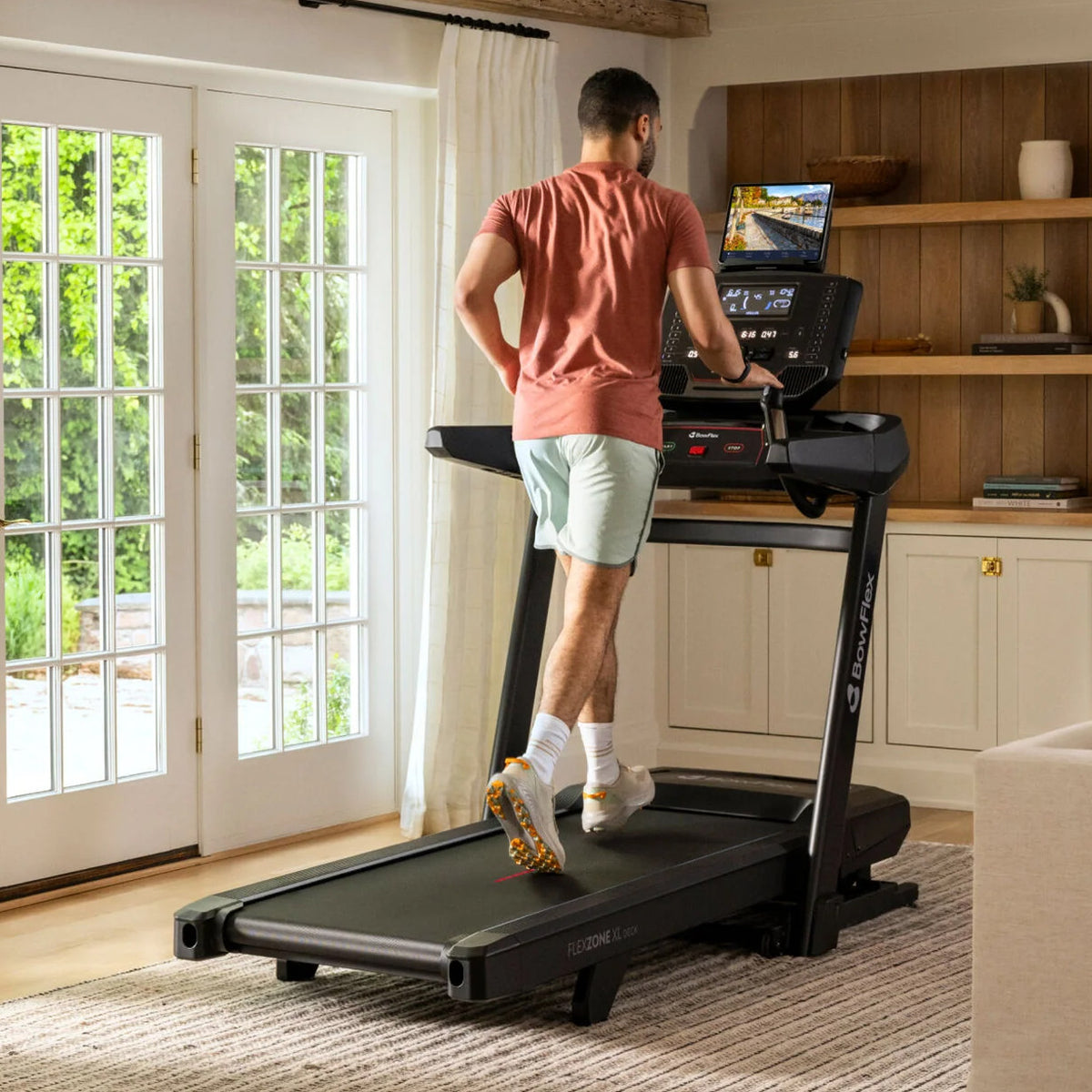 Kvinne som går på BowFlex T9 i et lyst rom